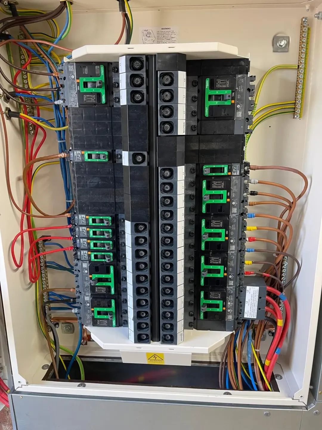 Interior of a distribution board showing circuit breakers and connected wiring