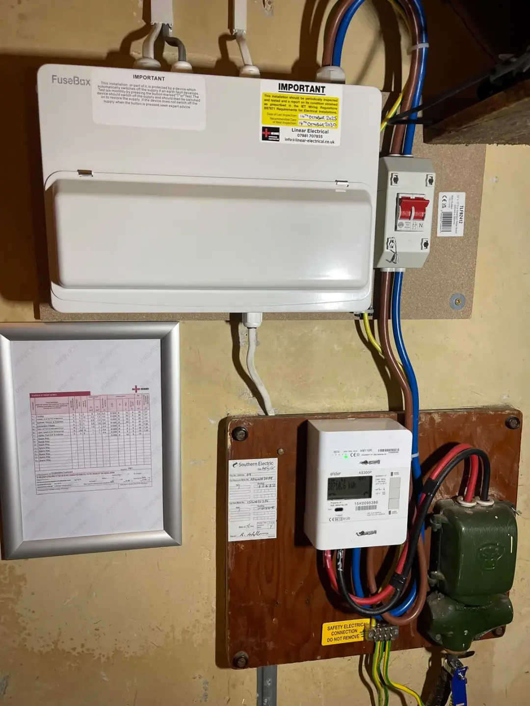 FuseBox consumer unit beside an electricity meter and red isolation switch