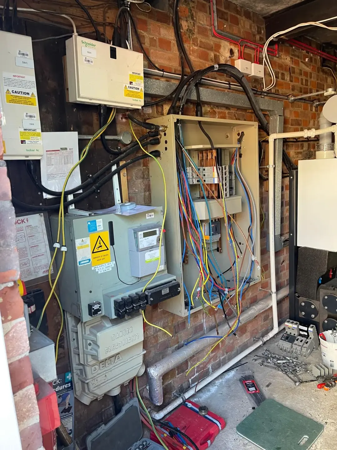Open distribution board with loose conductors during installation in a plant room